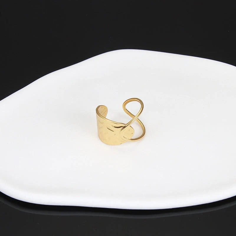 Adjustable stainless steel finger ring with unique charm designs in steel and gold finishes