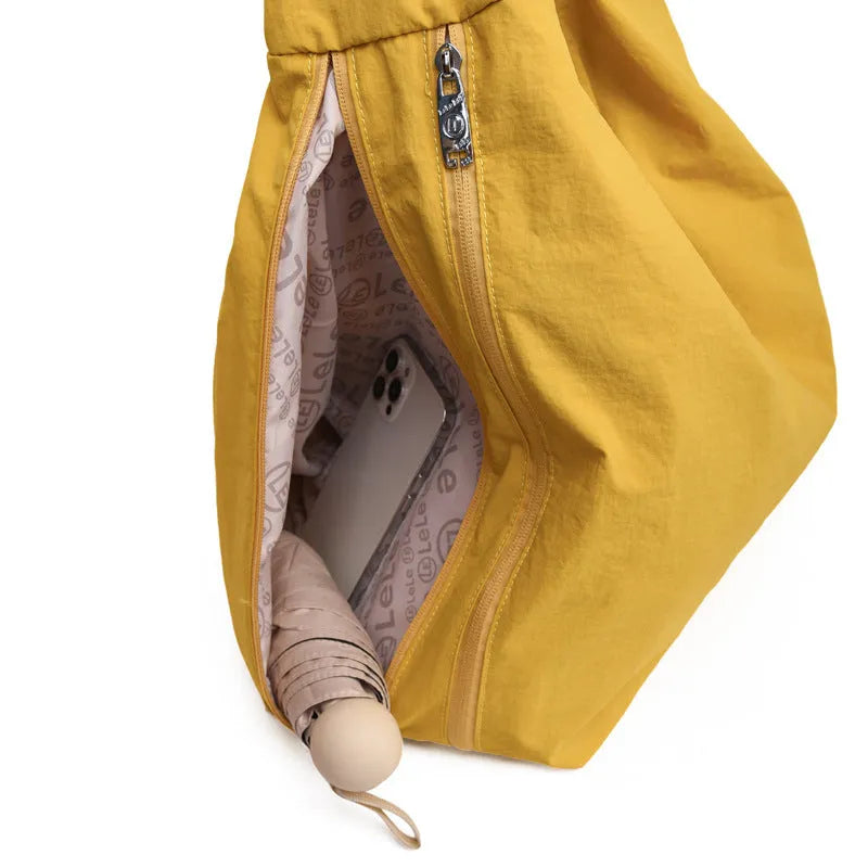 Nylon underarm bag for women with large capacity, soft heart-shaped design, crossbody messenger style, available in black, yellow, khaki, and blue colour choices.