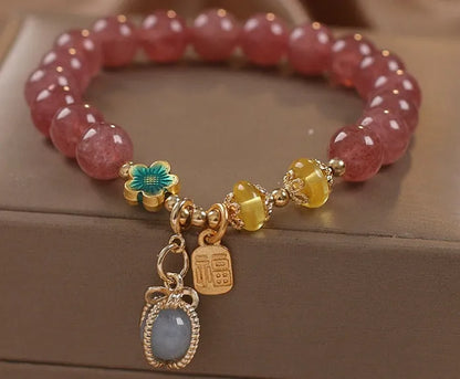 Red beaded bracelet with strawberry quartz gems, alloy clasp, and rhinestone details.