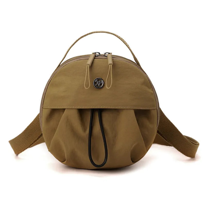 Out shoulder crossbody messenger bag in nylon showing interior zipped changing bag, phone pocket, and document compartment.