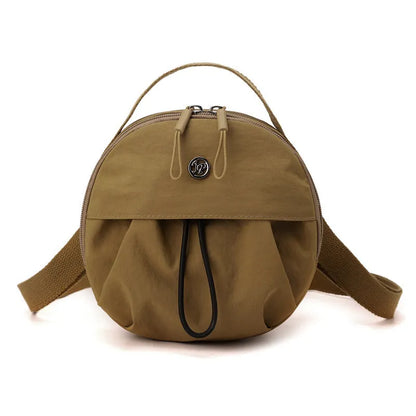 Out shoulder crossbody messenger bag in nylon showing interior zipped changing bag, phone pocket, and document compartment.