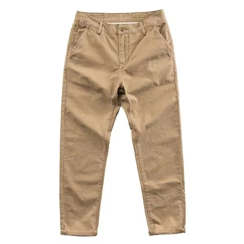Man wearing slim fit grey micro elastic washed trousers with a straight leg cut for a business casual look.