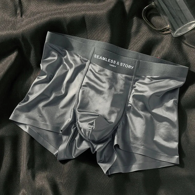 Men's solid colour satin ice silk boxer shorts laid flat, showing mid-waist design.
