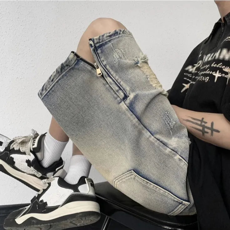 A pair of faded blue denim shorts with a tattered, distressed finish and a loose wide-leg silhouette.