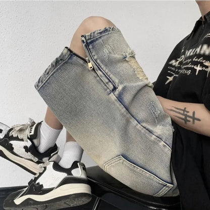 A pair of faded blue denim shorts with a tattered, distressed finish and a loose wide-leg silhouette.
