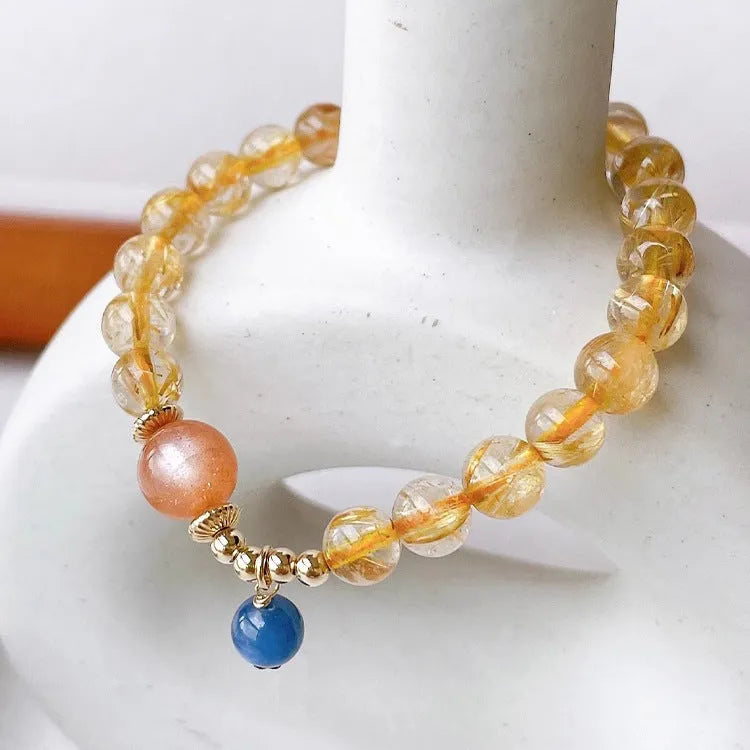 Gold rutilated quartz sunstone crystal bracelet with diamond shape and round elements for women
