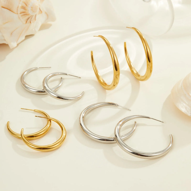 Titanium steel hoop earrings for women featuring 18K gold plating in PVD furnace, available in large or small size geometric round hoops with gold or steel finish for fashion OL style.