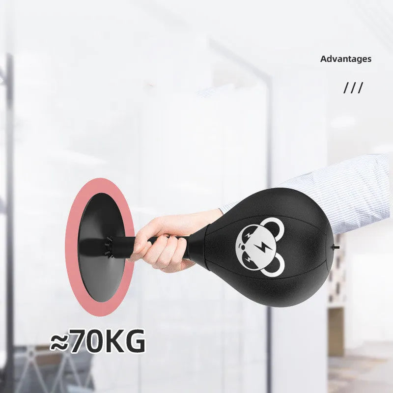 Tabletop boxing speed ball with suction cup base on a desk, showing burst bear design and flexible connection tube