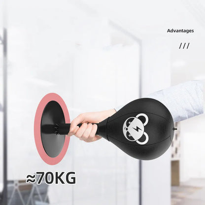 Tabletop boxing speed ball with suction cup base on a desk, showing burst bear design and flexible connection tube