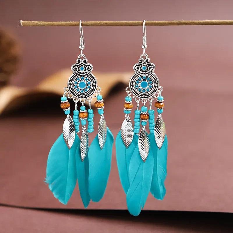 Round drop feather earrings in a bohemian leaf shape with patterned detail, shown in a light pink electroplated colour.