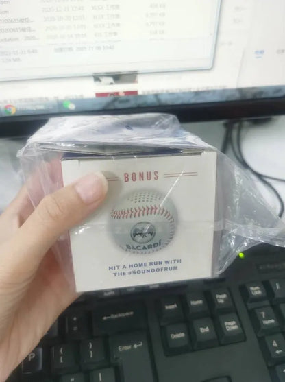 A green Bluetooth speaker shaped like a baseball with a USB port.