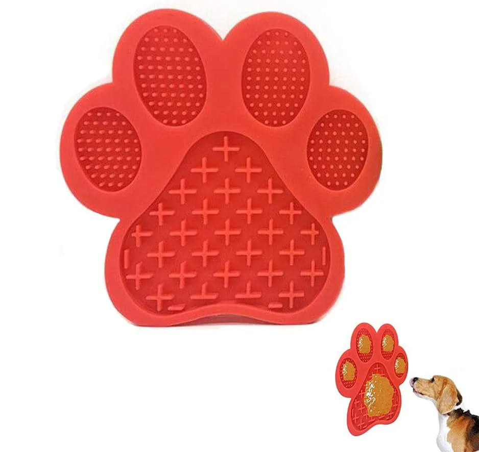 Bone-shaped blue silicone dog licking mat with suction cups on a tile surface
