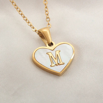 Gold-plated heart necklace with white shell pendant showing letter personalisation option