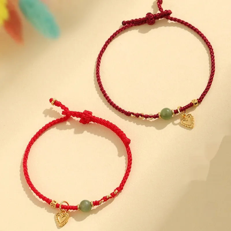 Handmade women's bracelet with 925 silver and Hetian jade in woven design with red carrying strap