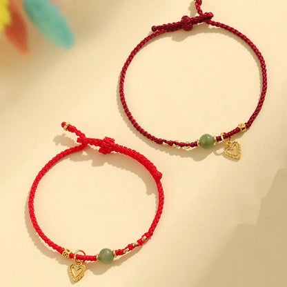 Handmade women's bracelet with 925 silver and Hetian jade in woven design with red carrying strap