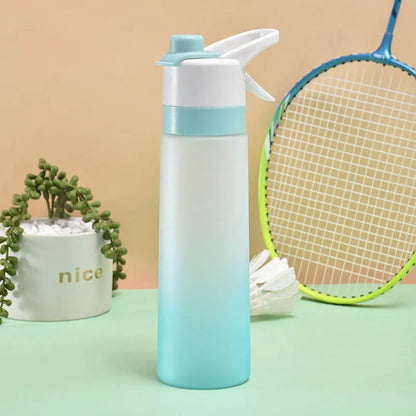 White spray water bottle with black leakproof lid and handle strap on a table