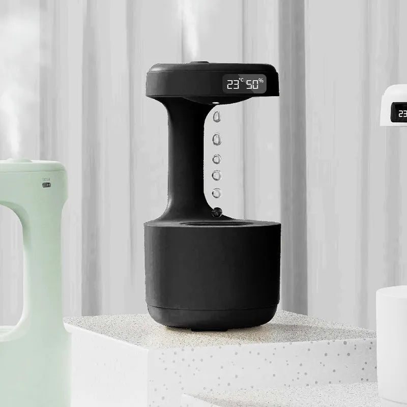 White columnar anti-gravity humidifier with water droplet backflow and LED clock display on a desk.