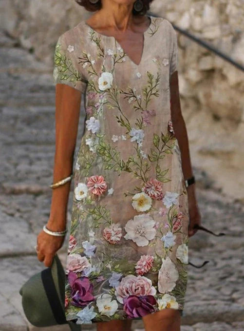 Elegant floral-printed cotton and linen midi dress in various colours with short sleeves and v-neck
