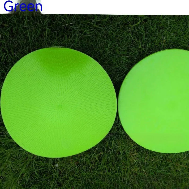 Soft yellow TPE football training landmark pad disc on grass, 23cm diameter.