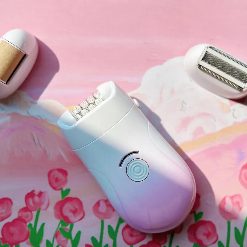 Pink three-in-one USB electric hair removal device with shaving head, grinding head, and skin rub attachment