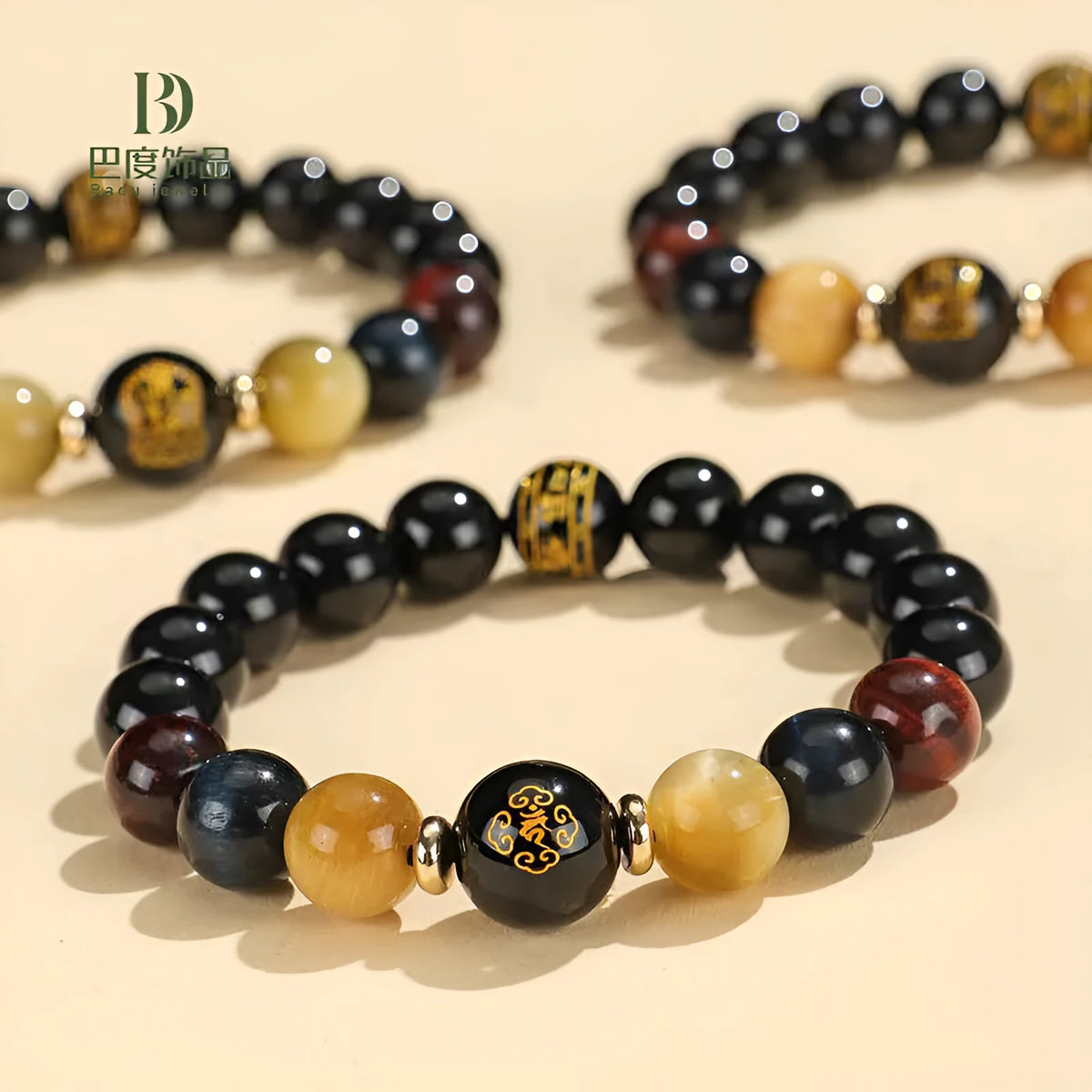 Handcrafted black agate and tiger eye stone beaded bracelet with a central carved zodiac deity charm.