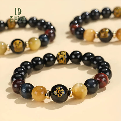 Handcrafted black agate and tiger eye stone beaded bracelet with a central carved zodiac deity charm.