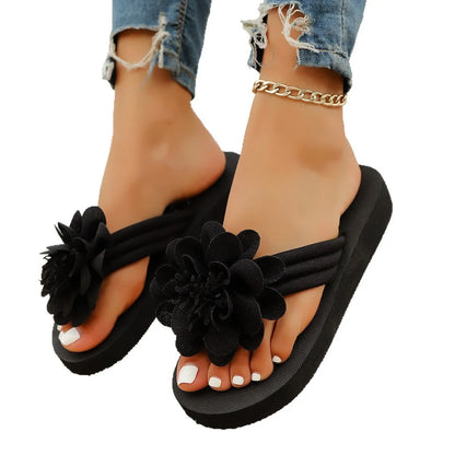 Solid-colour flower flip flops with a decorative floral detail on a viscose upper and EVA sole.