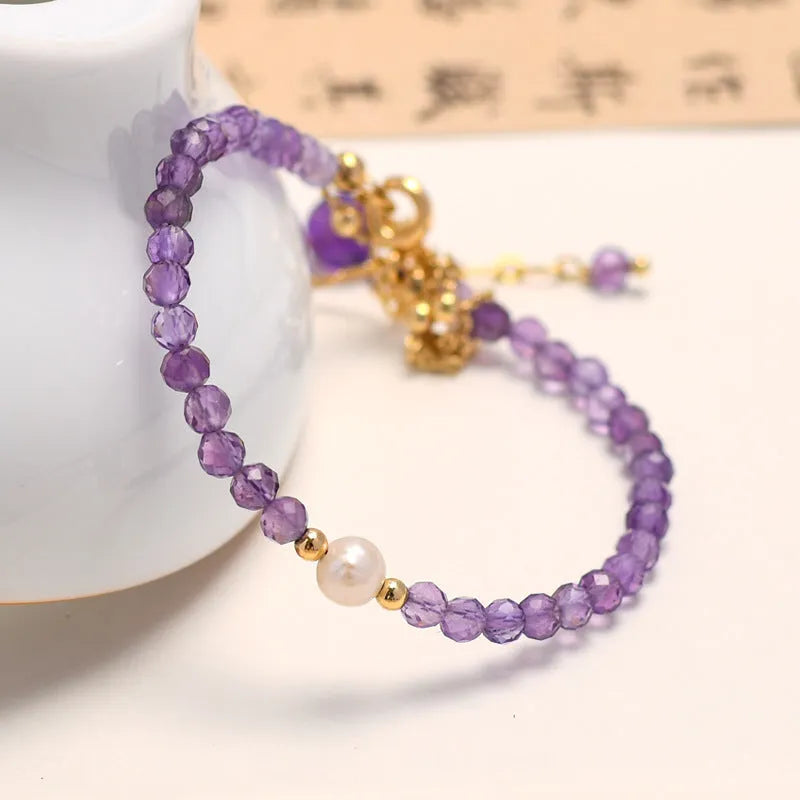 Amethyst coloured Chinese-style crystal bracelet with a diamond-shaped design and electroplated finish.