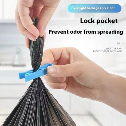 A white polypropylene plastic clip for holding a rubbish bag onto the rim of a bin.