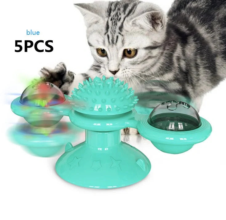 Cat playing with rotating windmill toy featuring luminous balls and suction base