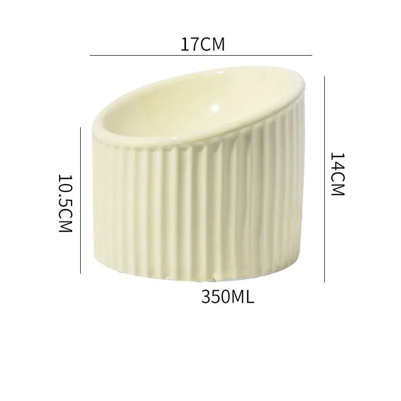Ceramic elevated cat bowl in green colour showing tilted, round whisker-friendly design.