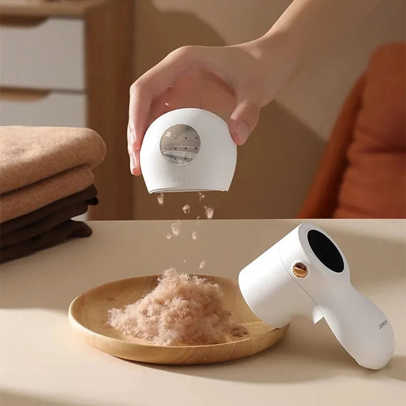 White electric lint remover with digital display showing six stainless steel blades and USB charging port