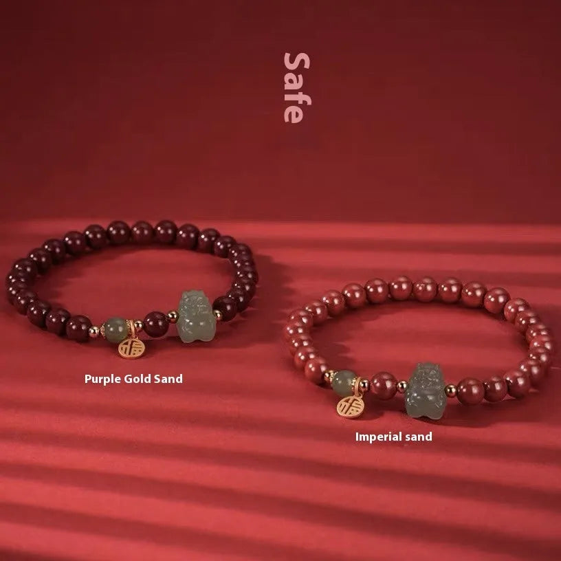 Natural Hetian jade bracelet with zodiac carvings and cinnabar accents in 8mm diameter