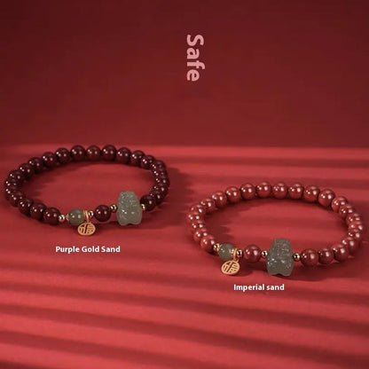 Natural Hetian jade bracelet with zodiac carvings and cinnabar accents in 8mm diameter