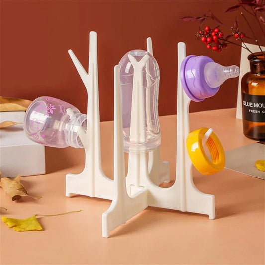 Creative Tree Branch Bottle Drying Rack for baby feeding bottles and accessories in blue, yellow, white, and nude