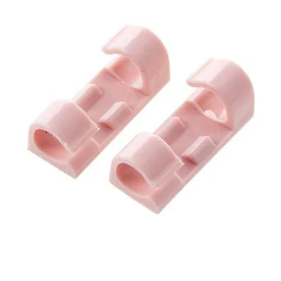 Self-adhesive plastic cable organiser clips in various colours holding a bundle of wires against a wall.