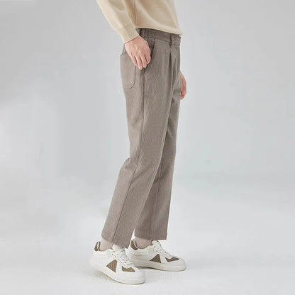 Men's straight-leg corduroy trousers in beige colour showing elastic waistband and loose fit