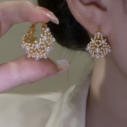 Gold-coloured women's floral basket earrings made from copper with small bead and pearl inlay detail.