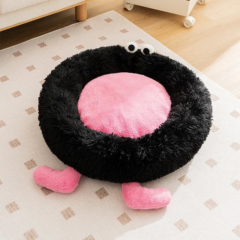 Blue plush kennel bed for dogs or cats with raised sides, shown in a home setting.