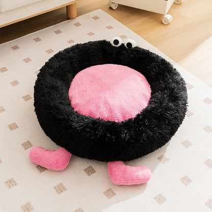 Blue plush kennel bed for dogs or cats with raised sides, shown in a home setting.