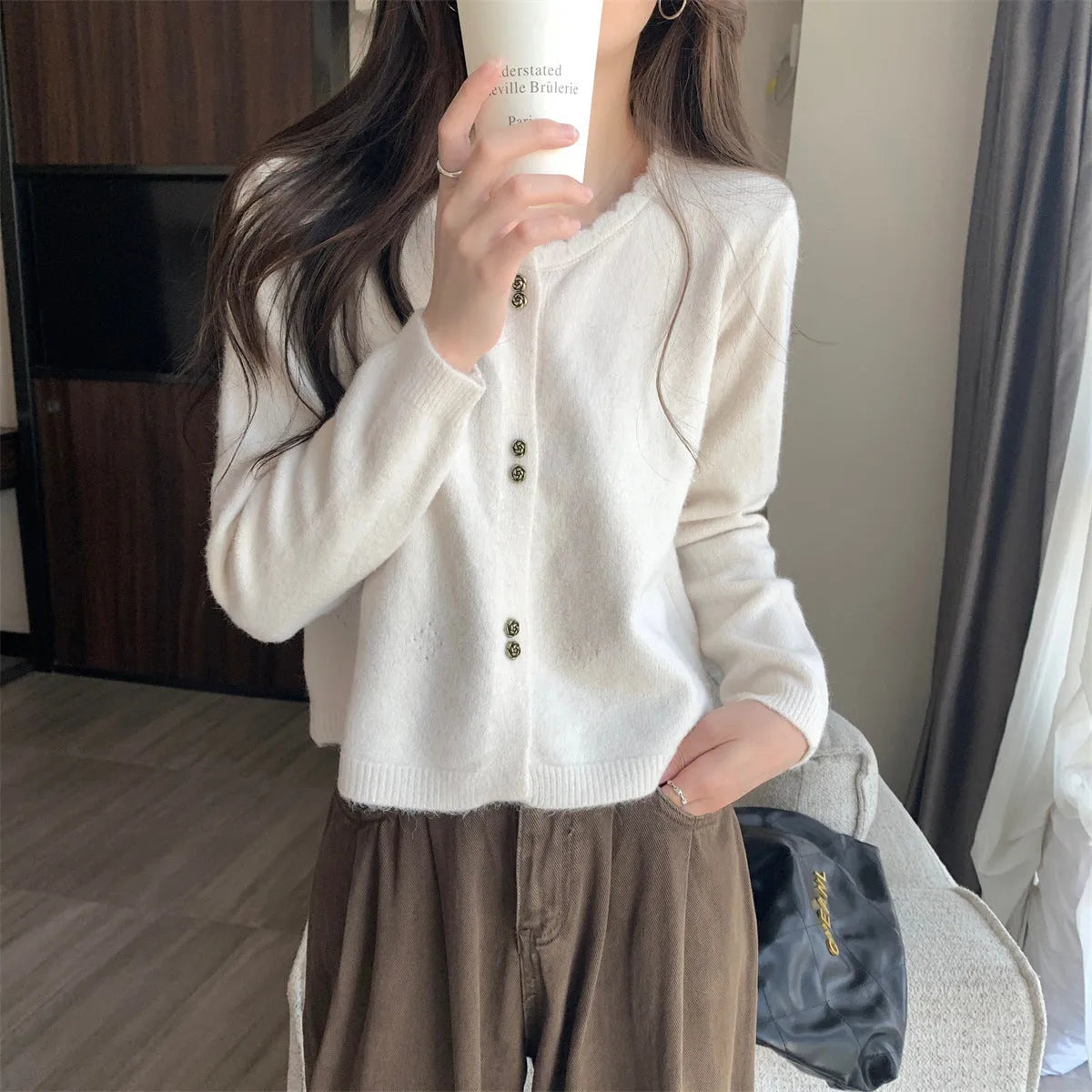 Women's milky white long sleeve acrylic cardigan sweater worn open, showing free size fit and regular sleeve design.