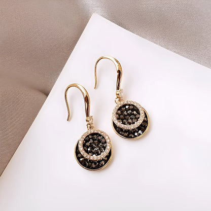Matte black geometric circle alloy earrings with retro Hong Kong style, shown from the front.