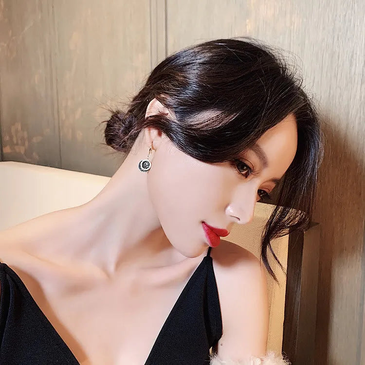 Matte black geometric circle alloy earrings with retro Hong Kong style, shown from the front.