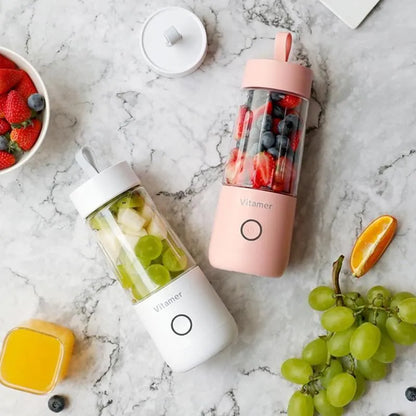 White portable USB rechargeable blender bottle with silicone handle on a Tritan cup.