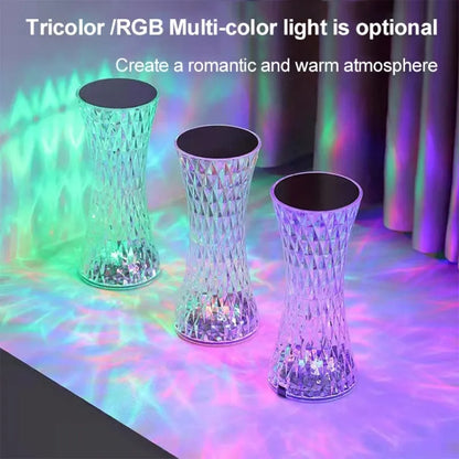 Vase-shaped crystal table lamp with remote control on a bedside table, showing diamond-like glow and USB charging port.