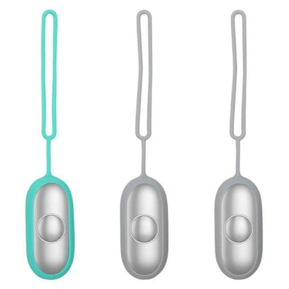 Hand-held micro-current sleep aid device in grey, green, or orange with round button and USB charging port