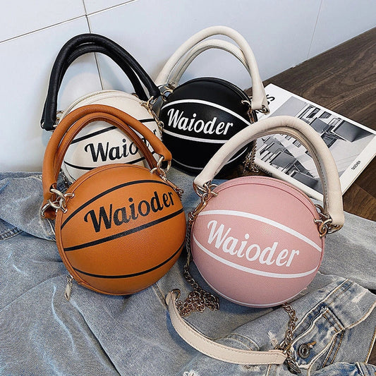 Basketball-shaped women's handbag in pink, white, black, and brown with adjustable shoulder strap