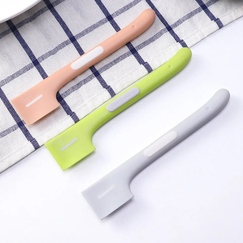 Green long-handle pet feeding spoon with right-angle head for scraping canned wet food.