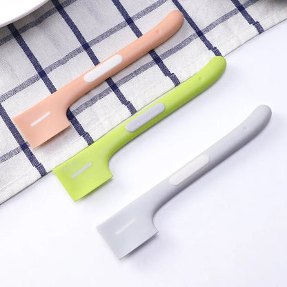 Green long-handle pet feeding spoon with right-angle head for scraping canned wet food.