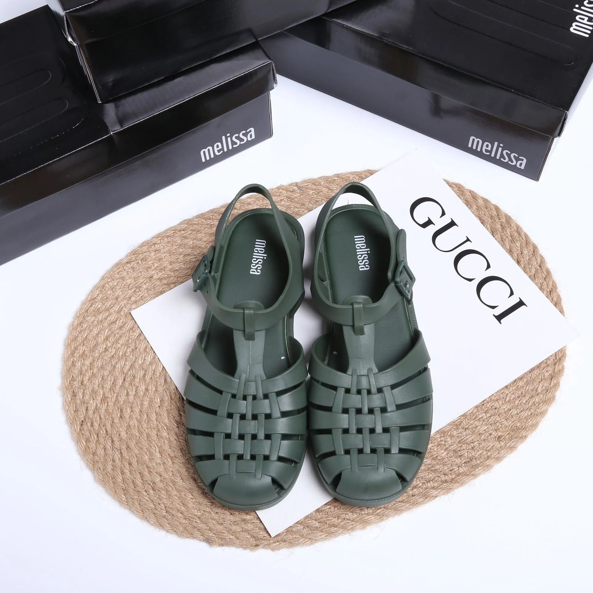Matte black Roman sandals with vintage weave pattern, buckle fastening, and low-top PVC construction